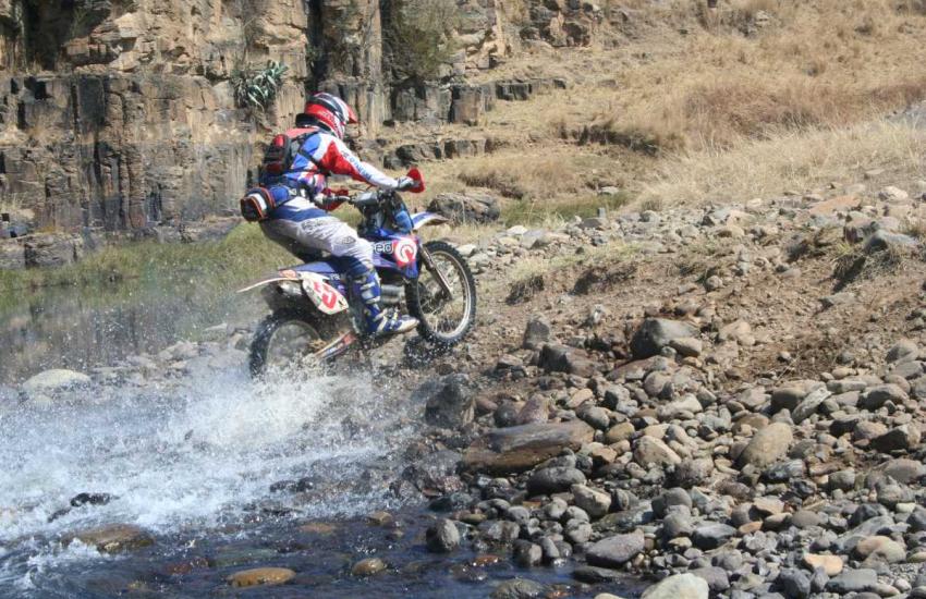 Off-road bike crossing a rocky Drakensberg river