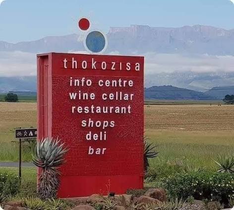 Thokozisa Lifestyle Centre sign with Drakensberg behind